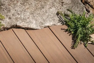 A close up of the multi width Elements decking install close up against some stones in the RHS Hampton Court garden